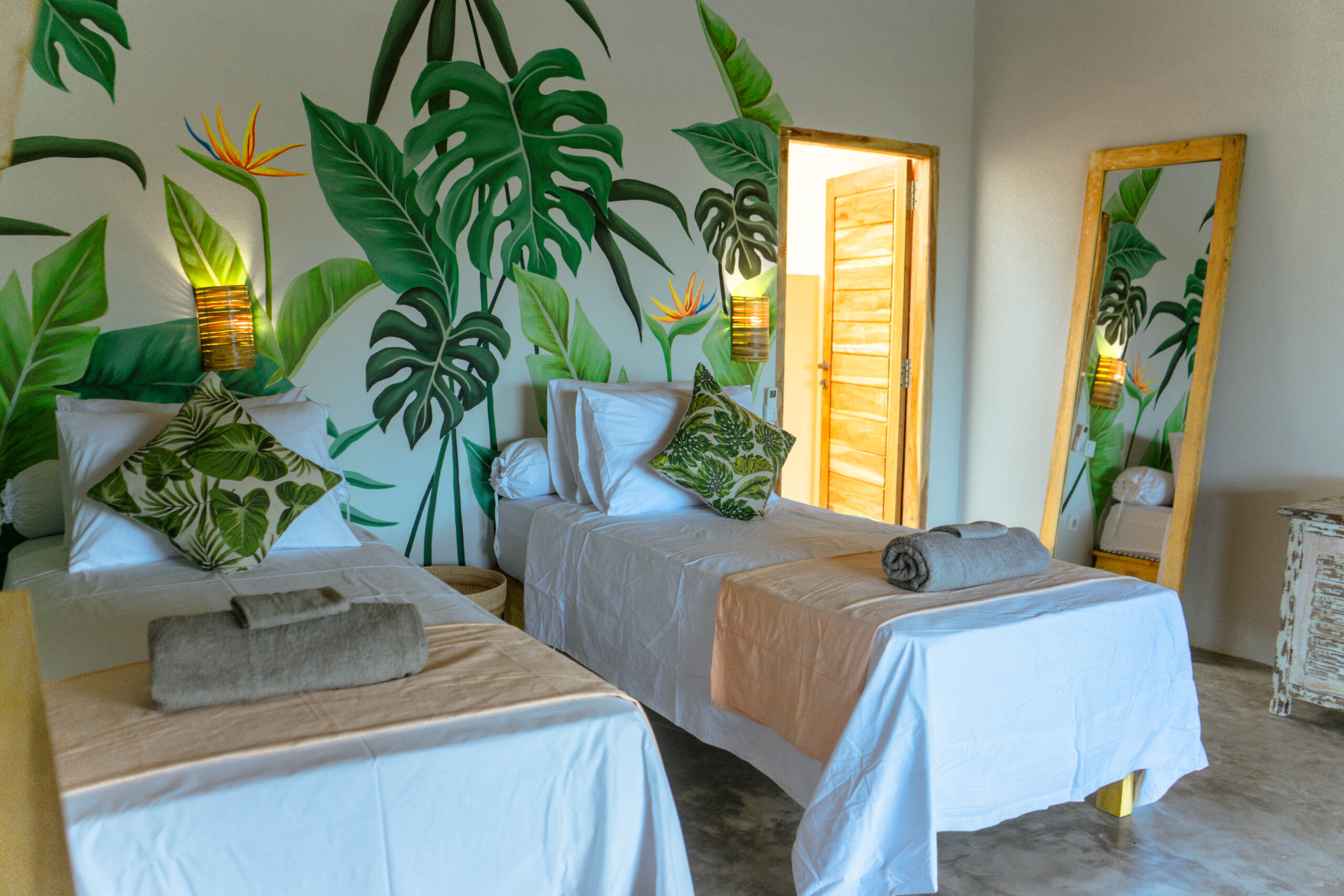FabuLous Place Lombok bedroom with a beautiful wall painting and 2 single beds