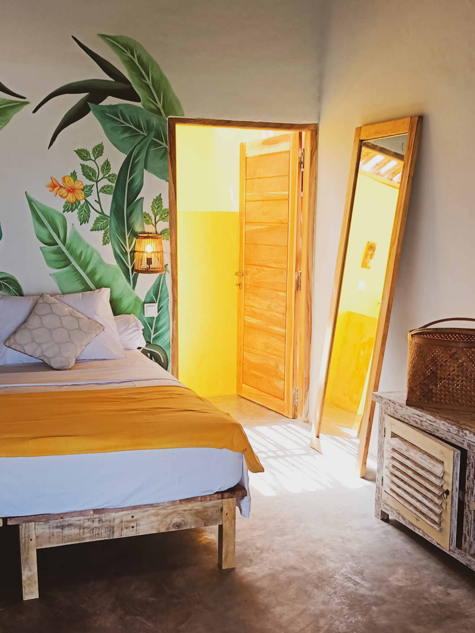 FabuLous Place Lombok surf villa yellow bedroom with wall painting and large floor mirror