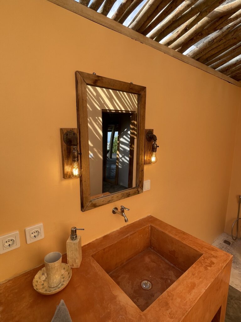 FabuLous Place Lombok surf villa orange sink and with nice industrial lights around wooden mirror